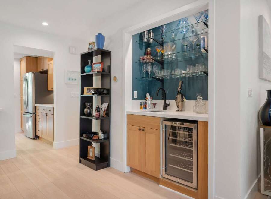 This modern home features a stylish wet bar with a built-in wine cooler, perfect for entertaining guests.