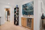 This modern home features a stylish wet bar with a built-in wine cooler, perfect for entertaining guests.