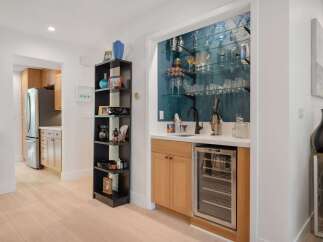 This modern home features a stylish wet bar with a built-in wine cooler, perfect for entertaining guests.