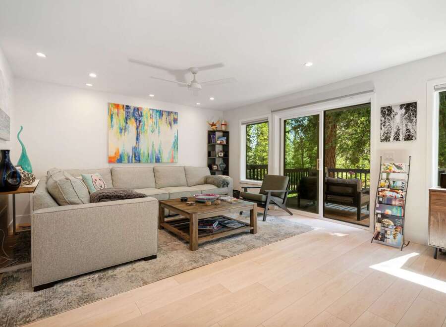 Experience modern living in this spacious living room, featuring a comfortable sectional sofa and a rustic wooden coffee table perfect for gatherings.