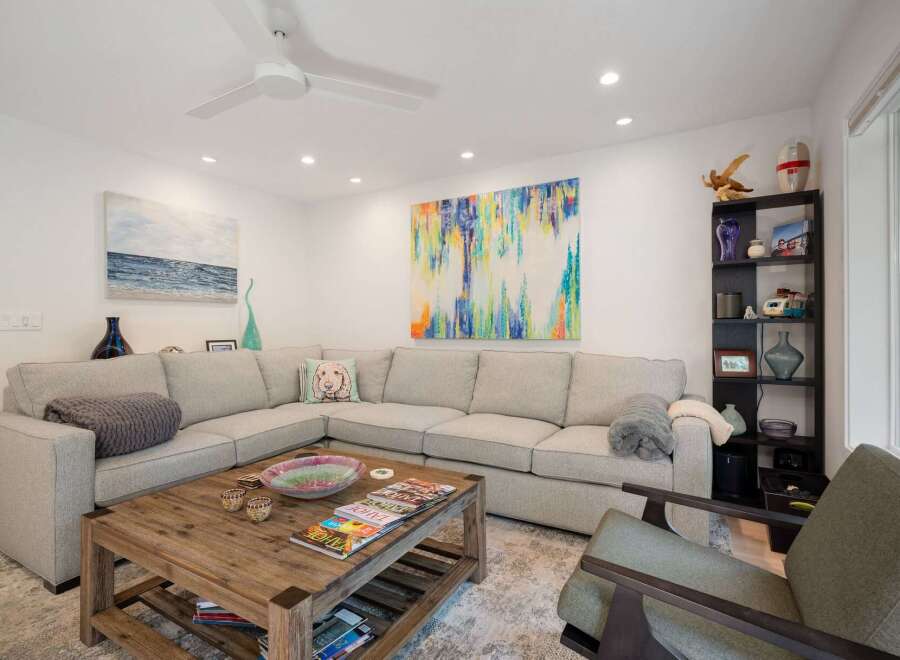 This spacious living room features a large sectional sofa perfect for family gatherings, complemented by a rustic wooden coffee table.