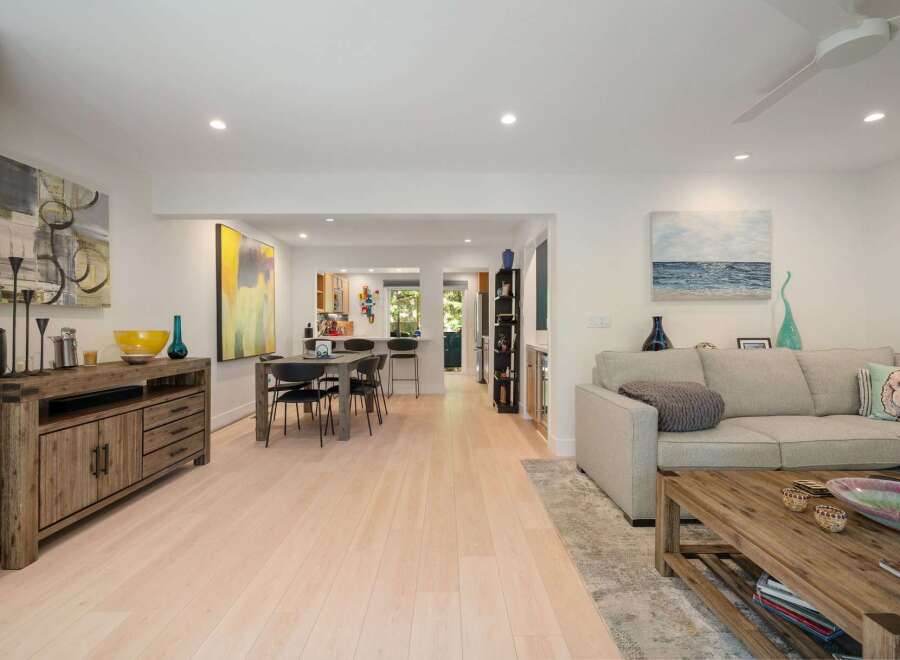 Experience modern living in this open-concept home featuring a spacious living area, a stylish dining space, and a well-equipped kitchen perfect for entertaining.