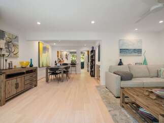 Experience modern living in this open-concept home featuring a spacious living area, a stylish dining space, and a well-equipped kitchen perfect for entertaining.