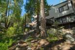 Nestled amidst towering pine trees, this multi-level home offers a unique mountain retreat.
