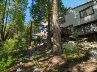 Nestled amidst towering pine trees, this multi-level home offers a unique mountain retreat.
