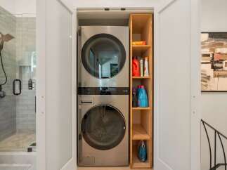 Discover the ultimate convenience with this stacked LG washer and dryer unit, perfectly integrated into a compact laundry space.