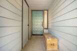 Step into this charming entryway featuring a light blue paneled door, perfect for welcoming guests.