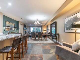 Experience elegant open-concept living with a spacious dining area and a modern kitchen island, perfect for entertaining.