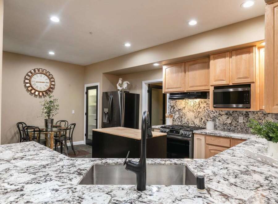 Experience the heart of this home with a stunning kitchen featuring granite countertops and a spacious island.