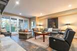 Experience luxurious living in this inviting living room, featuring a plush sectional sofa and comfortable armchairs perfect for relaxation.