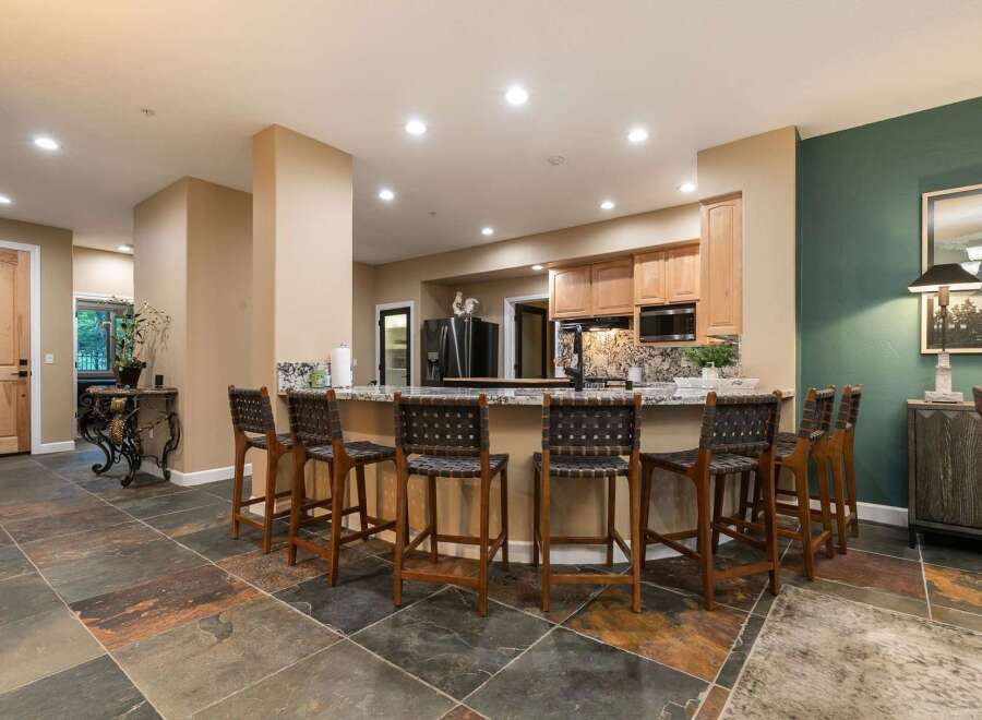 Experience seamless entertaining in this stunning kitchen and dining area, featuring a spacious granite island with comfortable bar seating.
