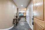 Step into this inviting entryway featuring elegant slate tile flooring and a decorative console table with a potted plant.