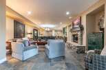 This spacious living area features a large stone fireplace as the focal point, perfect for cozy evenings.