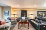 This inviting living room features a plush gray sofa and two comfortable armchairs, perfect for relaxation.
