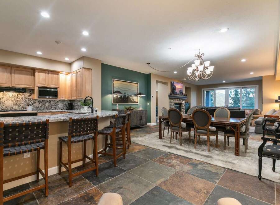 Experience luxurious mountain living in this stunning open-concept home, featuring a gourmet kitchen with granite countertops and a spacious island perfect for entertaining.