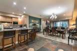 Experience luxurious mountain living in this stunning open-concept home, featuring a gourmet kitchen with granite countertops and a spacious island perfect for entertaining.