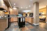 Experience the perfect blend of style and functionality in this stunning kitchen, featuring elegant wood cabinetry and a sleek granite countertop.