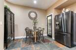 This dining area features a stylish glass-top table with four chairs, perfect for intimate meals.