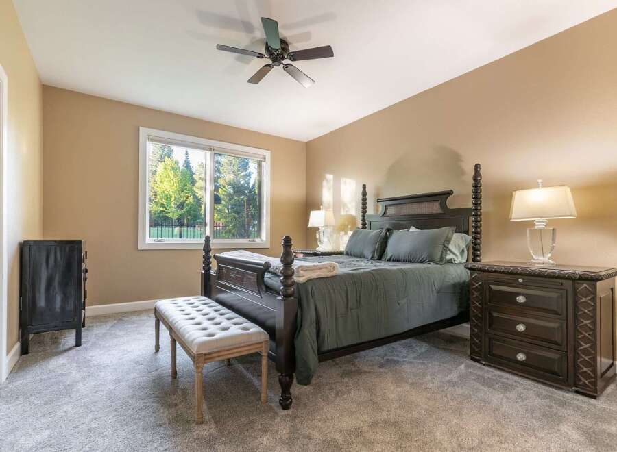 Experience ultimate comfort in this master bedroom, featuring a luxurious king-size bed with plush bedding and a cozy throw.