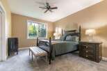 Experience ultimate comfort in this master bedroom, featuring a luxurious king-size bed with plush bedding and a cozy throw.