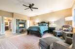Experience luxury and comfort in this master suite, featuring a grand dark wood bed adorned with teal bedding.