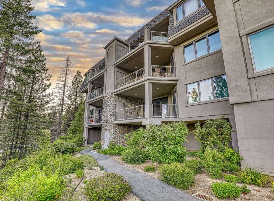 Experience luxury living in this stunning multi-story residence, featuring multiple balconies with breathtaking views and a unique stone facade.