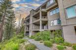 Experience luxury living in this stunning multi-story residence, featuring multiple balconies with breathtaking views and a unique stone facade.