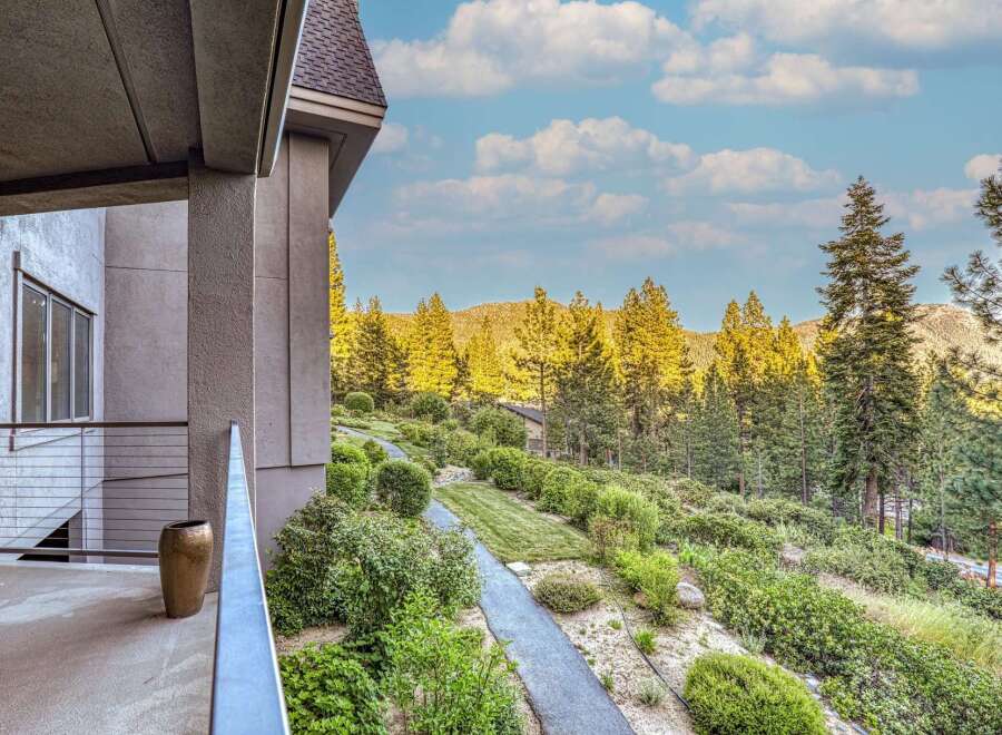 Experience luxury living with this stunning property offering breathtaking mountain views and lush landscaping.