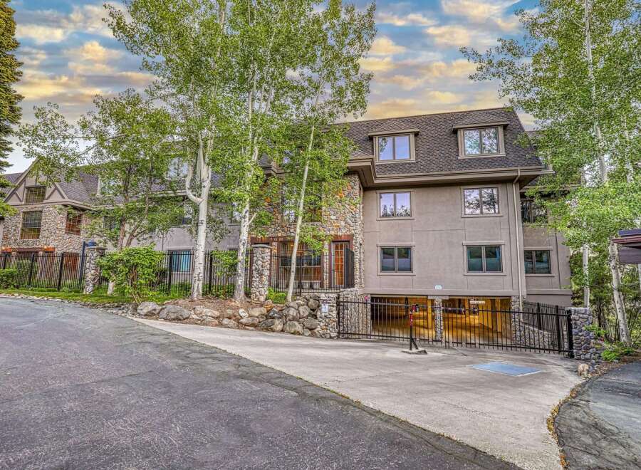 Discover luxury living in this stunning multi-story residence, featuring a striking stone facade and elegant stucco exterior.