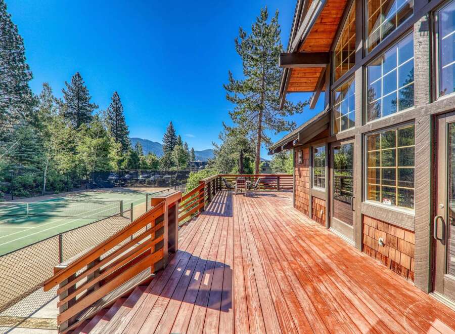 Enjoy stunning mountain views from this expansive wooden deck, perfect for entertaining or relaxing outdoors.