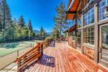 Enjoy stunning mountain views from this expansive wooden deck, perfect for entertaining or relaxing outdoors.