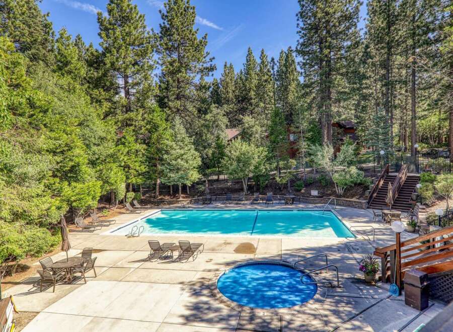Escape to this serene mountain retreat featuring a sparkling swimming pool and a relaxing hot tub, perfect for unwinding after a day of adventure.
