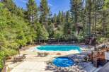 Escape to this serene mountain retreat featuring a sparkling swimming pool and a relaxing hot tub, perfect for unwinding after a day of adventure.
