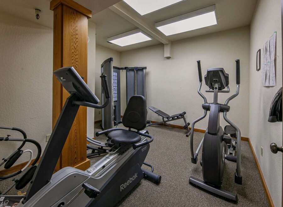 Stay active and energized in this well-equipped fitness center, featuring a variety of cardio machines including an elliptical and a recumbent bike.