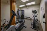 Stay active and energized in this well-equipped fitness center, featuring a variety of cardio machines including an elliptical and a recumbent bike.