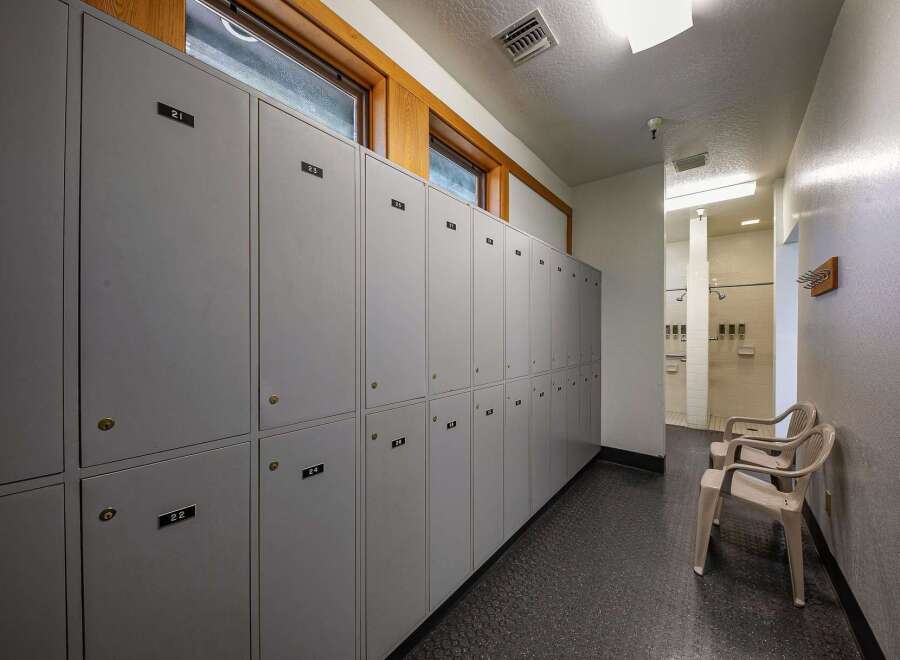 Discover a functional locker room space featuring rows of grey lockers, each with individual numbering for easy organization.