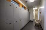 Discover a functional locker room space featuring rows of grey lockers, each with individual numbering for easy organization.