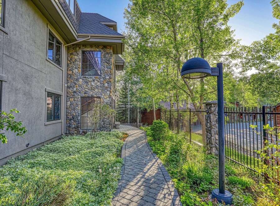 Discover this charming property featuring a unique stone facade and a welcoming paved walkway leading to the entrance.
