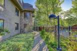 Discover this charming property featuring a unique stone facade and a welcoming paved walkway leading to the entrance.