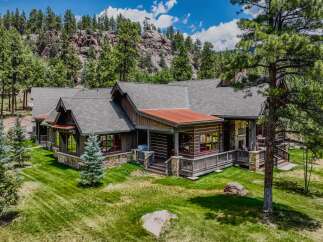 Nestled amidst a serene mountain landscape, this stunning log home offers a perfect blend of rustic charm and modern luxury.