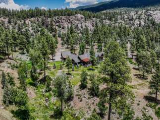 Nestled amidst a lush pine forest, this stunning mountain home offers unparalleled privacy and natural beauty.