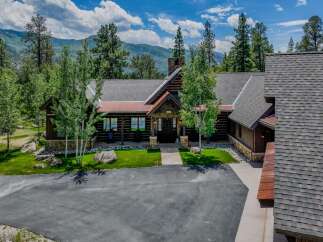 Experience rustic luxury in this stunning log home, nestled amidst breathtaking mountain scenery.
