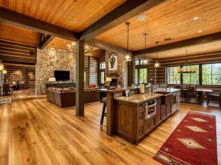 Experience rustic luxury in this stunning log cabin home, featuring an open-concept living space with a grand stone fireplace and a gourmet kitchen.