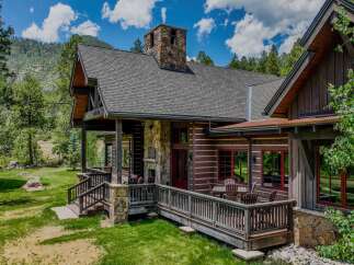 Experience rustic luxury in this stunning log cabin home, nestled amidst a picturesque mountain landscape.