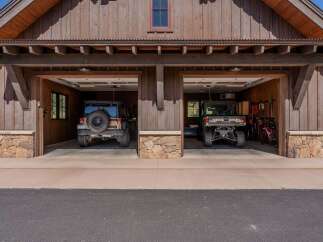 Discover this charming rustic garage featuring two spacious bays, perfect for storing vehicles and outdoor gear.