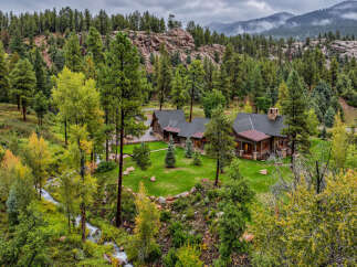 Nestled amidst a lush pine forest and rolling hills, this stunning mountain retreat offers unparalleled natural beauty and serene living.