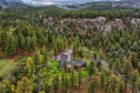Nestled amidst a dense pine forest and rugged rock formations, this stunning property offers a secluded mountain retreat.