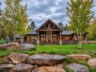 Experience rustic luxury in this stunning log cabin home, nestled amidst a picturesque landscape.