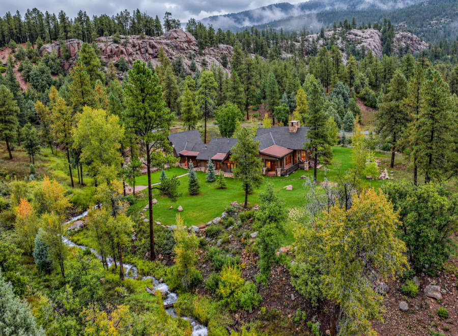Nestled amidst a lush forest and a babbling creek, this stunning mountain home offers unparalleled tranquility and natural beauty.