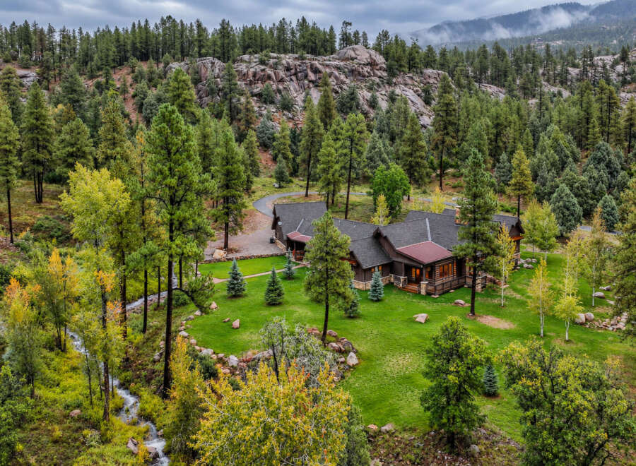 Nestled amidst a lush forest and rolling hills, this stunning property offers a serene mountain retreat.